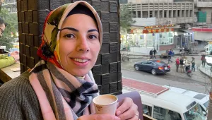 Marsin Alshamary enjoying a coffee on a balcony in Baghdad, Iraq.
