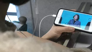 A traveler on a train from Kaohsiung to Taipei watches the news about Taiwanese President Tsai Ing-wen’s re-election on Sunday, January 12, 2020.