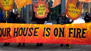 Opponents of Enbridge Energy's proposal to replace its aging Line 3 crude oil pipeline across northern Minnesota demonstrate on Friday, Jan. 31, 2020, outside the state Capitol complex in St. Paul, Minn. The opponents say the project would aggravate climate change.