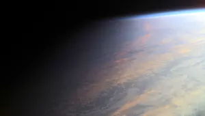 the passage of day into night in this view of ocean and clouds over Earth