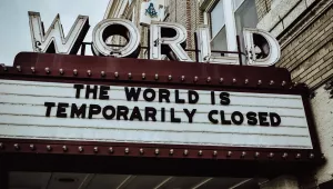 The World Theater's sign reads: "The World is Temporarily Closed"