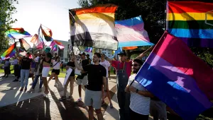 Protesters wave pride flags