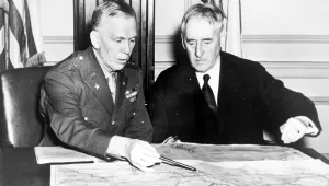 George C. Marshall, Chief of staff, and Henry L. Stimson, Secretary of War, confer over a map in the War Department