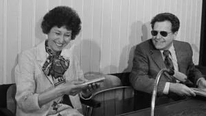 Gunter Guillaume, former personal aide to ex-chancellor Willy Brandt, hands chocolate to his wife Christel, as they meet in the dock at the start of their trial