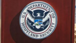 A close up of the U.S. Department of Homeland Security seal on the front of a wooden podium.