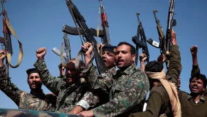 Houthi fighters hold their weapons on January 3, 2017.
