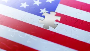 An illustration of the American flag with a jigsaw puzzle piece missing.