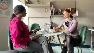 Ada Ezeokoli and Mariana Budjeryn sit at a table and have a conversation