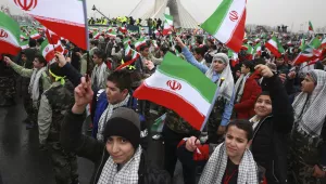 Children wave Iranian flags during a ceremony celebrating the 40th anniversary of the Islamic Revolution in Azadi Square