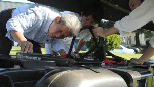 Dr. Hiroyuki Obara inspects his solar-hydrogen vehicle
