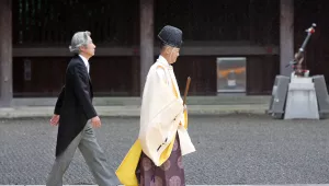 Japanese Prime Minister Junichiro Koizumi follows a Shinto priest toward the sanctuary of the Yasukuni war shrine
