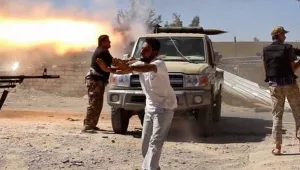 In this video screenshot, fighters from the Islamist Misarata brigade fire towards Tripoli airport in an attempt to wrest control from a powerful rival militia, in Tripoli, Libya, Saturday, July 26, 2014. On Saturday, the U.S. evacuated its diplomats in Tripoli to neighboring Tunisia and shut its embassy.