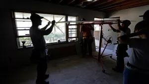 volunteers from Baptists On Mission and Home Builders Institute work at the home of Clifton Hall, assisting with ongoing repairs due to damage caused by Hurricane Florence