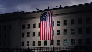 A large American flag is unfurled at the Pentagon