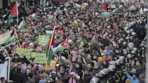 Protesters carry Jordanian and Palestinian flags and slogans during a protest against the Middle East peace plan proposed by U.S. President Donald Trump, in the center of Amman, Jordan, Friday, Jan. 31, 2020. 