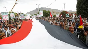Houthi supporters chant slogans holding signs reading "Death to America, Death to Israel"