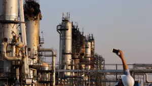 a cameraman films Aramco's oil processing facility after the recent Sept. 14 attack 