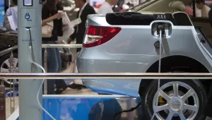 visitors tours the BYD Co. booth displaying an electric vehicle with a charger at the Shanghai International Auto Show