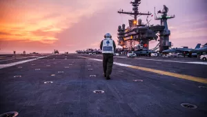 U.S. Navy Capt. Greg Fenton, commanding officer of the U.S. Navy's forward-deployed aircraft carrier USS George Washington walks across the ship's flight deck after flight operations in South China Sea.