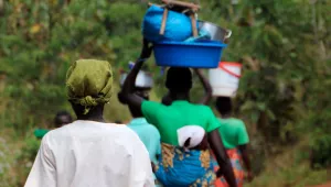 People walk back from a market