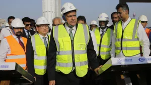 Sri Lankan prime minister Ranil Wickremesinghe, center, watches the land that was reclaimed from the Indian Ocean for the Colombo Port City project