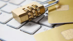 A lock on top of a keyboard and credit cards