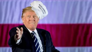 Donald Trump throws a hat into the audience 