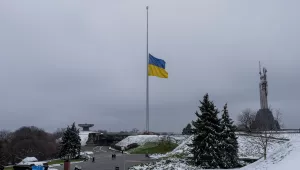 The Ukrainian flag flatters at half mast near the Ukrainian Motherland monument