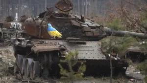 A destroyed Russian tank with an artwork depicting a dove with an olive branch by famous street artist TvBoy, amid Russia's attack on Ukraine, in the village of Dmytrivka, outside Kyiv, Ukraine Monday, Jan. 30, 2023.