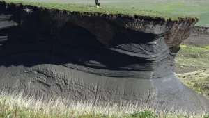 Thawing permafrost and subsequent soil erosion reveal ground ice and frozen soil underneath the surface. Herschel Island (Qikiqtaruk), Yukon, Canada.