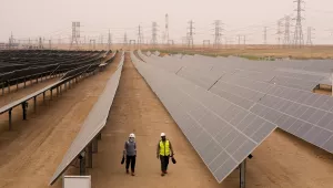 Engineers walk next to solar panels at Benban Solar Park in Aswan, Egypt.