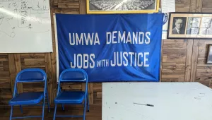 A banner bearing the slogan “UMWA demands jobs with justice” hangs on the wall at the United Mine Workers of America career center in Beckley, West Virginia.