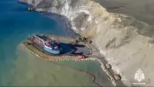 Russian rescuers work using a path along the narrow around the damaged Volgoneft-239 tanker to prevent leaking the fuel oil into the sea.