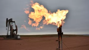 A flare burns natural gas at an oil well in Watford City, N.D., Aug. 26, 2021.