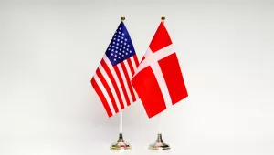 U.S. and Danish flags on a white background.
