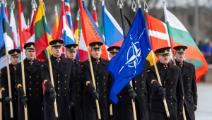 Lithuania's military officers march with flags of many nations during a military parade ceremony marking the 106th anniversary of the Lithuanian military, on Armed Forces Day, in Vilnius, Lithuania, Saturday, Nov. 23, 2024.
