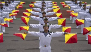 Chinese sailors show flag signaling during a tour arranged for foreign journalists, a day before the opening of the West Pacific Naval Symposium in Qingdao in eastern China's Shandong province, Sunday, April 21, 2024.