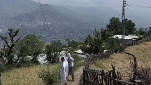 Villager women walk on a dusty track during a government's organized trip for media to Bella Noor Shah, a mountainous village near Muzaffarabad, the capital of Pakistan administered Kashmir, Monday, May 5, 2025. 