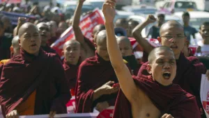 In this Friday, Jan. 16, 2015 file photo, Myanmar Buddhist monks shout slogans as they march to protest against a resolution adopted by the UN General Assembly calling on Myanmar to grant citizenship to Rohingya in Yangon, Myanmar. 