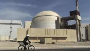 FILE - A worker rides a bicycle in front of the reactor building of the Bushehr nuclear power plant, just outside the southern city of Bushehr, Iran, Oct. 26, 2010.