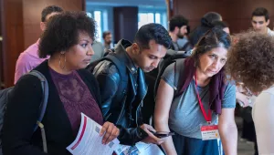 Students speaking with a member of the Belfer team during the 2024 Open House