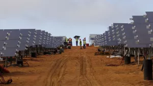 Workers install solar panels at a photovoltaic solar park situated on the outskirts of the coastal town of Lamberts Bay, South Africa on March. 29, 2016.