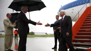 Former Defense Secretary Robert Gates, right, is greeted by former U.S. Ambassador to NATO Ivo Daalder as he deplanes at Brussels National Airport in Brussels, Wednesday, June 9, 2010. (AP Photo/Carolyn Kaster, Pool)