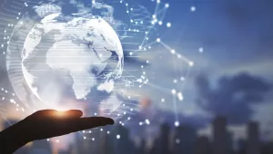 A hand beneath a glowing stylized version of the globe