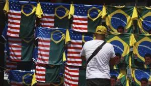 A vendor displays dual flag jerseys featuring the Brazilian and U.S. flag, outside the condominium where former President Jair Bolsonaro is under house arrest in Brasilia