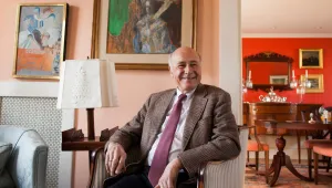 Photo of Joe Nye sitting in a chair, smiling