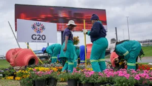 City park employee plant flowers along one of Johannesburg's major highway as a massive cleanup job gets underway in anticipation of the upcoming G20 summit to be held in the South African economic capital, Friday, Nov. 14, 2025. (AP Photo/Jerome Delay)