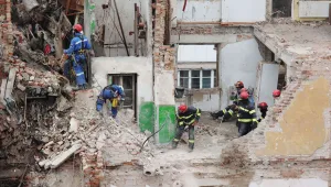 Rescue workers clear the rubble of a residential building which was heavily damaged by a Russian strike on Ternopil, Ukraine, Friday, Nov. 21, 2025.