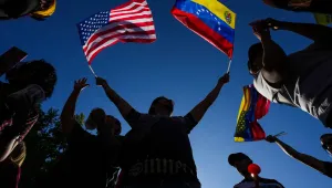 Venezuelans celebrate in Santiago, Chile, Saturday, Jan. 3, 2026, after U.S. President Donald Trump announced that President Nicolas Maduro had been captured and flown out of Venezuela. (AP Photo/Esteban Felix)