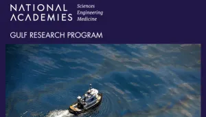 A boat moves through an oil spill.